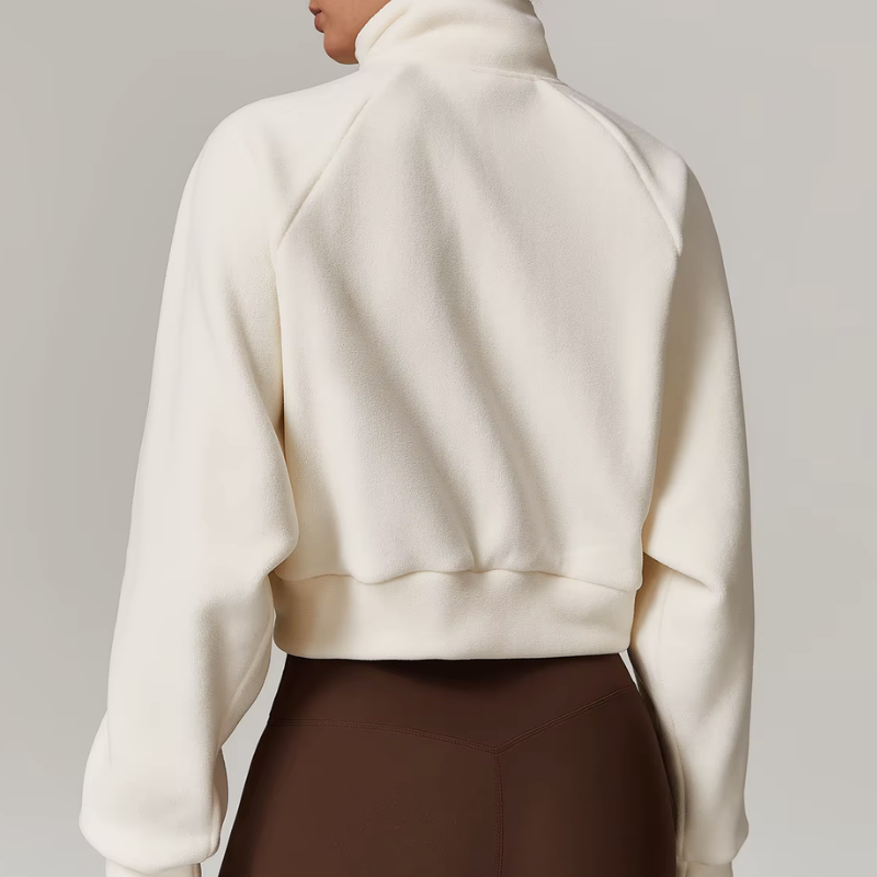 Side profile of women's fleece zip-up jacket with slit pockets