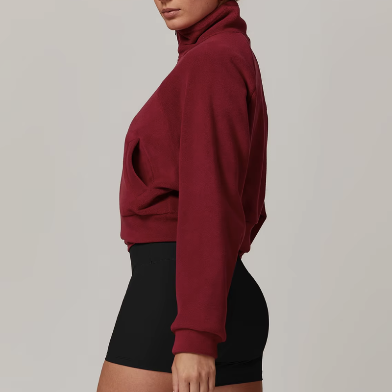 Side profile of women's fleece zip-up jacket with slit pockets