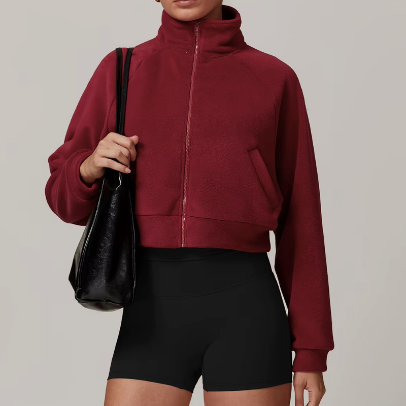 Side profile of women's fleece zip-up jacket with slit pockets