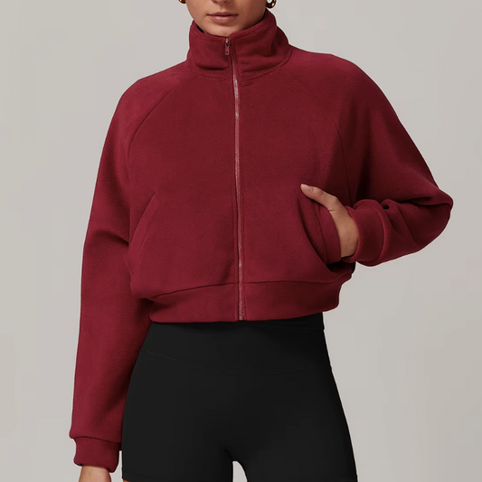 Side profile of women's fleece zip-up jacket with slit pockets
