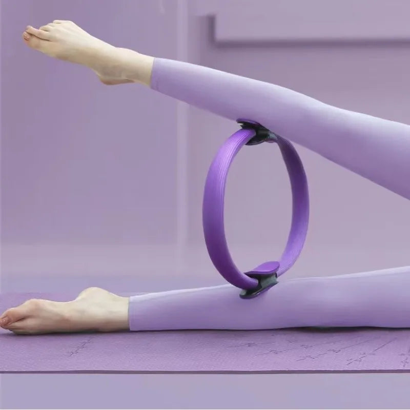 Pilates ring with ergonomic foam handles used for pelvic muscle strengthening and stretching.