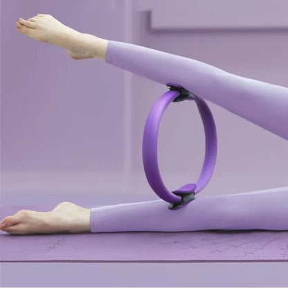 Pilates ring with ergonomic foam handles used for pelvic muscle strengthening and stretching.