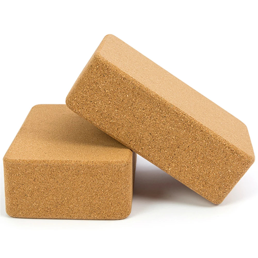 Two eco-friendly cork yoga blocks with beveled edges.