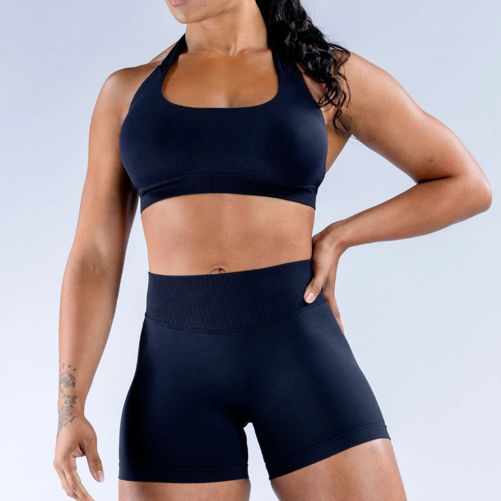 Halter neck seamless everyday sports bra for women in black, medium support.