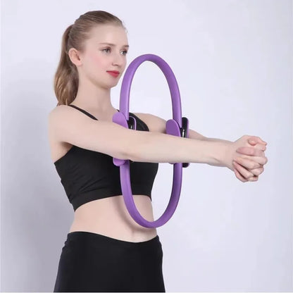 Pilates ring with ergonomic foam handles used for pelvic muscle strengthening and stretching.